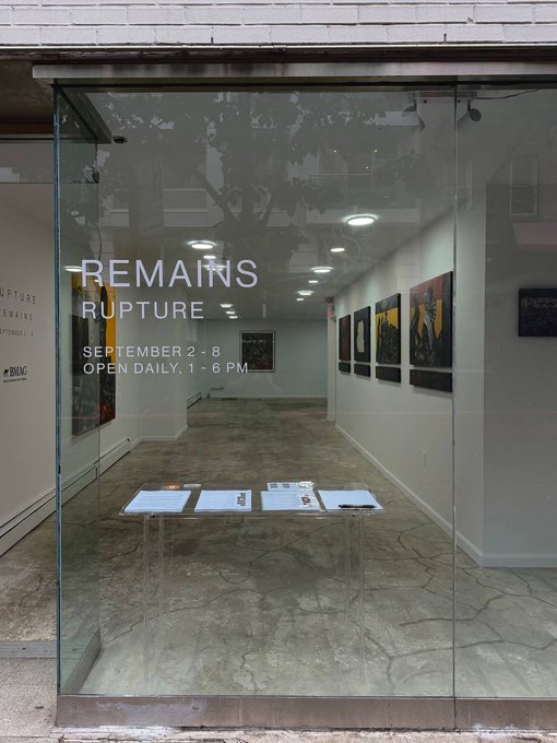 The glass entrance to an art gallery exhibition titled 'REMAINS RUPTURE' running 'SEPTEMBER 2-8, OPEN DAILY, 1-6 PM'.