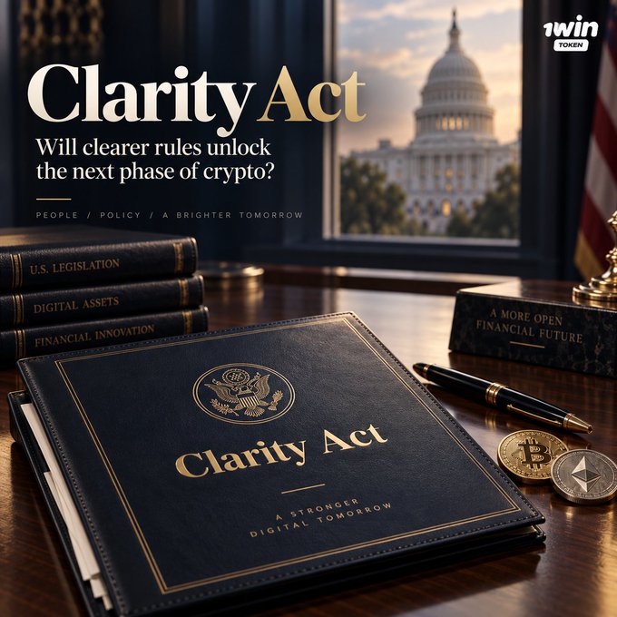 A promotional graphic for the 'Clarity Act' featuring a dark blue book titled 'Clarity Act' on a wooden desk, alongside books on 'U.S. LEGISLATION', 'DIGITAL ASSETS', and 'FINANCIAL INNOVATION', with the US Capitol building visible in the background and the text '1WIN TOKEN' in the corner.