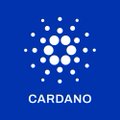 The image displays the Cardano logo, featuring white geometric dots arranged in a circular pattern against a blue background, with the text "CARDANO" prominently shown below. The logo visually represents the Cardano blockchain platform referenced in the post about the successful Van Rossem hard fork upgrade enacted entirely through on-chain Voltaire governance.