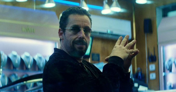 The image features an actor dressed in a black shirt, standing in front of a store window display with his hands up. The man appears to be making a gesture or posing for the camera, possibly indicating that he is participating in a promotional event or advertisement related to basketball. The text "me betting on the basketball game in hyperliquid not knowing a single thing about the sport" suggests that there might be some connection between the actor's actions and an ongoing basketball-related event or promotion.