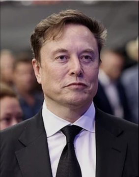 A close-up portrait of Elon Musk in a dark suit and tie.