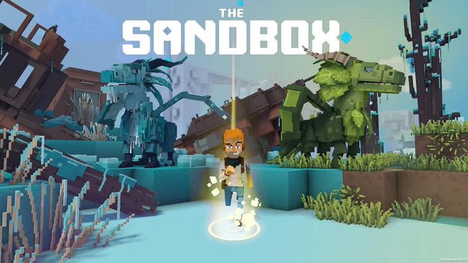 A promotional image for the video game 'THE SANDBOX', showing a blocky voxel character with glowing elements standing in a pixelated landscape with large dinosaur-like creatures.