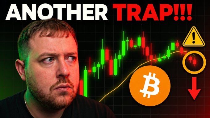 The image shows a man with a concerned expression alongside a Bitcoin price chart displaying candlestick patterns, with the bold headline "ANOTHER TRAP!!!" and warning symbols including a Bitcoin logo and downward red arrow. This visually emphasizes the post's alert that "BITCOIN JUST BROKE SUPPORT: THIS IS DANGEROUS!!!!" by conveying urgency and bearish sentiment about BTC's price movement.