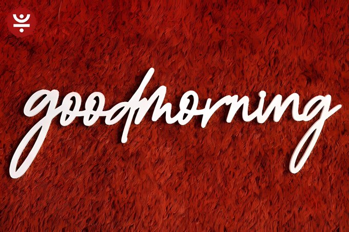 A graphic with a red furry texture background featuring the word 'goodmorning' written in white cursive script, with a small logo in the top left corner.