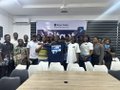 A group of attendees and presenters pose together at the @BitgetWalletAF Prediction Market Event, where one attendee is holding a framed certificate or award, reflecting the engaging atmosphere described in the post about trying out the @BitgetWallet Prediction Market.