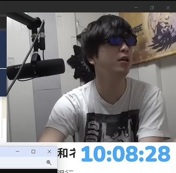 A person with dark hair and purple sunglasses sits in front of a microphone in what appears to be a streaming setup, with a timestamp reading "10:08:28" displayed at the bottom. The image likely illustrates the "Today" portion of the before-and-after comparison mentioned in the post, showing the streamer after his stress-induced acne had healed.