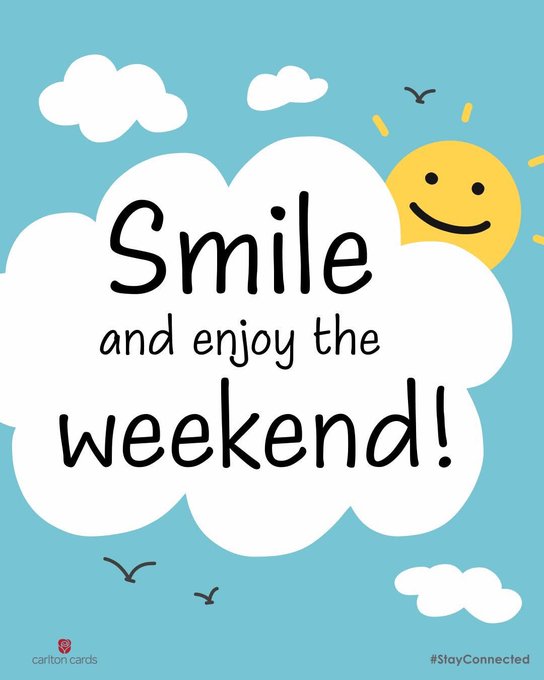 The image features a poster that reads "Smile and enjoy the weekend!" The poster has a blue background with white clouds and a yellow sun. There are also birds flying around, adding to the overall cheerful atmosphere of the scene. The text on the poster is in black cursive font, making it easy to read.