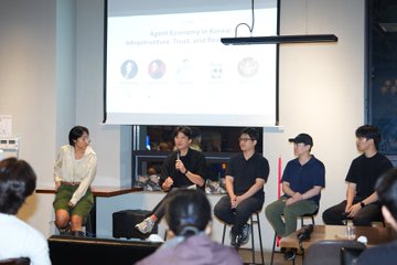 A panel discussion at "Proof of AI: Korea Special Edition" in Seoul features a moderator interviewing four seated guests on stage, with the presentation slide "Agent Economy in Practice" visible on the screen behind them, directly illustrating the post's theme of addressing trust and authorization for AI agents in the economy.