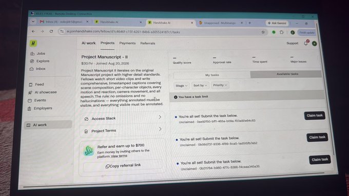 A laptop screen displaying the Handshake AI platform, showing a project titled 'Project Manuscript - II' worth $20/hr involving short video clips and captions for AI training.