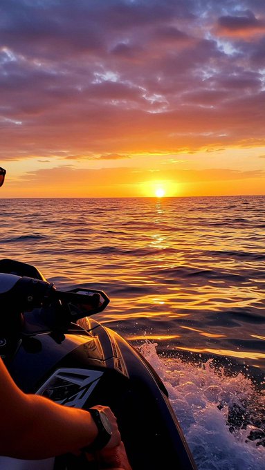 A first-person view from a jet ski on calm ocean waters captures a breathtaking golden sunset, with the rider's wristwatch visible as they cut through the water, perfectly matching the serene "Good morning fam" vibe of an early morning ride.