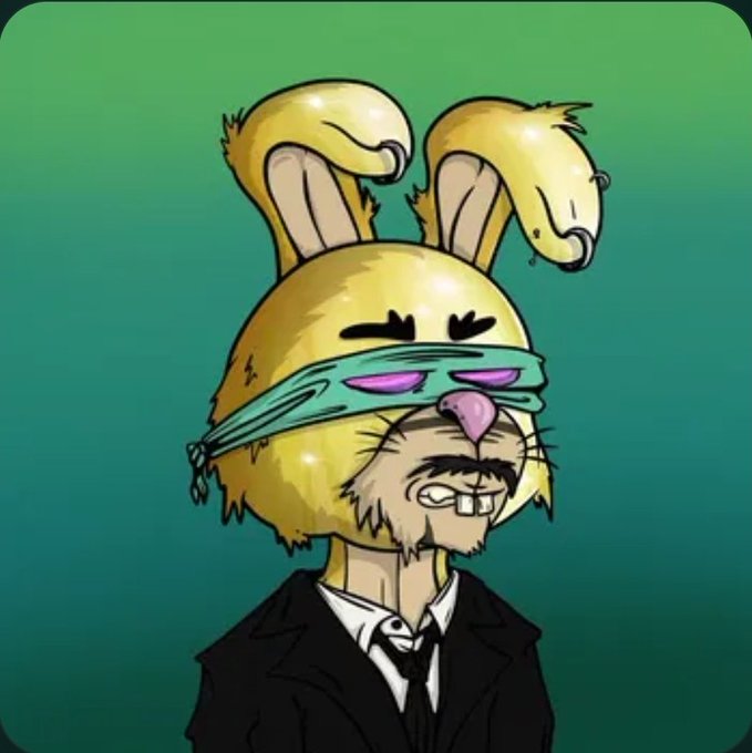 A digital illustration of a stylized character wearing a yellow rabbit-eared hood with a teal blindfold, dressed in a suit.