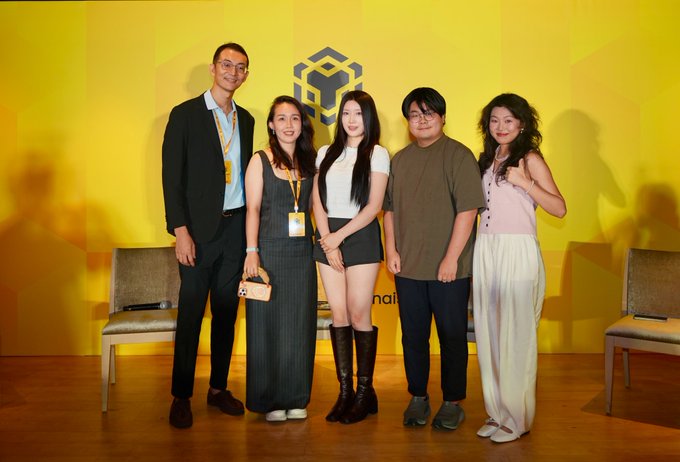 Five panelists—representatives from Unitas Labs, Renaiss, zERC20, and Atlas Oracle—pose together on stage in front of a yellow backdrop featuring a geometric cube logo, marking the first panel discussion of the evening on yield, privacy, and the future of onchain finance.