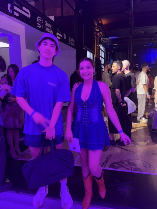 Two people pose at the "Solana" Summer House event, with signage reading "Home of the Degens" and step counts visible in the background, capturing the moment the user met @MINHxDYNASTY to discuss trading wins and losses in the vibrant, purple-lit venue.