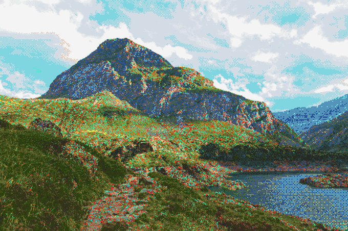 A pixelated landscape image showing a mountain peak with autumn foliage, a blue lake, and cloudy sky in a stylized digital art style.
