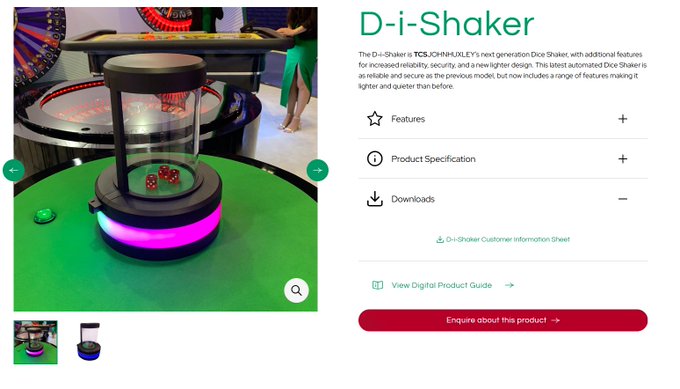 The image shows a product page for TCSJOHNHUXLEY's "D-i-Shaker," an automated dice shaker featuring a clear cylindrical housing on an illuminated base, with accompanying text highlighting features like increased readability, security, and a lighter design. The accompanying caption jokes about leveraging the device's built-in camera and machine-learning recognition to record dice outcomes and generate cryptographic seeds from physical randomness.