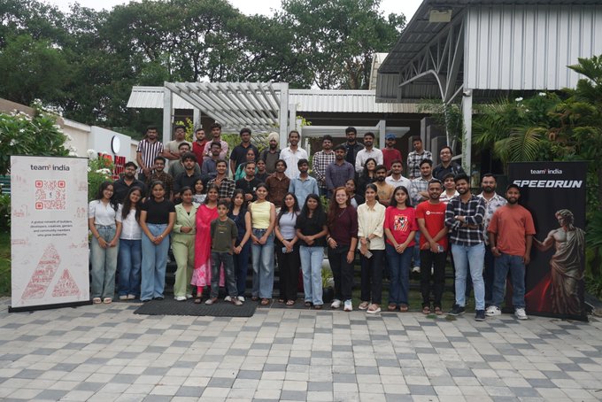 A group photo of 'Team India' participants gathered at an event for 'SPEEORUN,' posed together outdoors on a tiled patio.