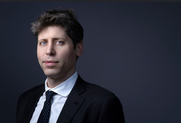 A professional headshot of Sam Altman, CEO of OpenAI, wearing a dark suit and tie against a dark blue background.