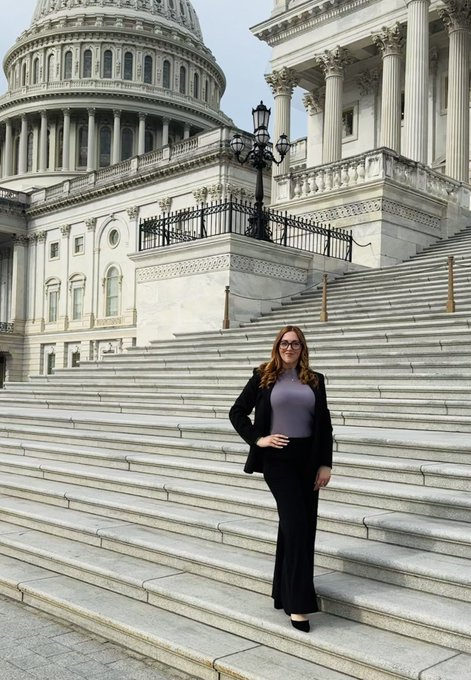 A woman in a black blazer and purple top stands confidently on the steps of the U.S. Capitol building in Washington, DC. The image captures her during a day of advocacy meetings with Senators to discuss the CLARITY Act and promote clear regulation for digital assets.