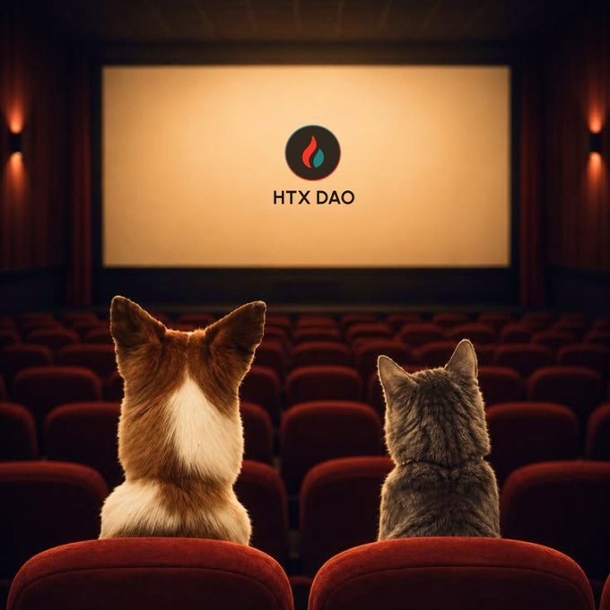 Two cats (a Corgi and a gray tabby) sit in red theater seats watching a movie screen displaying the 'HTX DAO' logo with a flame icon.