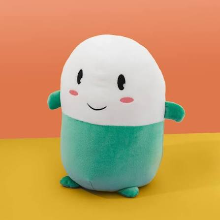 A cute white and teal plush toy with a simple smiling face and rosy cheeks, photographed against a split orange and yellow background.