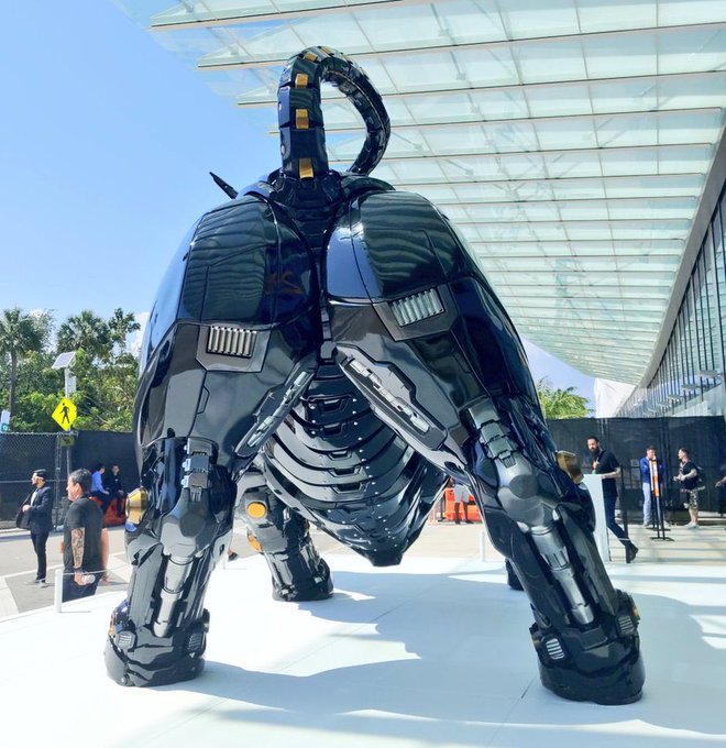 A massive black and chrome robotic bull sculpture is displayed at what appears to be an Apple Store event, standing on all fours without its reproductive anatomy, directly illustrating the post's claim that "The Bitcoin bull has no balls."