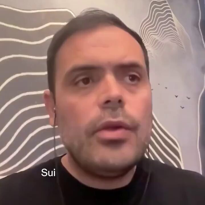 The image features a man wearing earbuds with his face clearly visible against a black background. The caption of the image reads "BREAKING Sui'S programmable object model is revolutionizing the blockchain space with its universal compatibility and flexibility, making it ready for whatever comes next". This suggests that the man's focus on the post might be due to the intriguing concept behind the Sui programmable object model or a recent development in the blockchain technology.