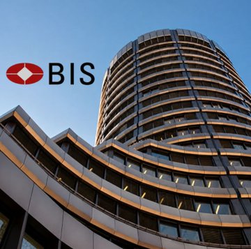 Exterior view of a curved modern building displaying the 'BIS' logo, representing the Bank for International Settlements.