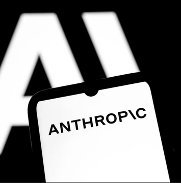 A black-and-white close-up image showing the word 'ANTHROPIC' printed on a white surface in the foreground, with large, out-of-focus letters in the background.