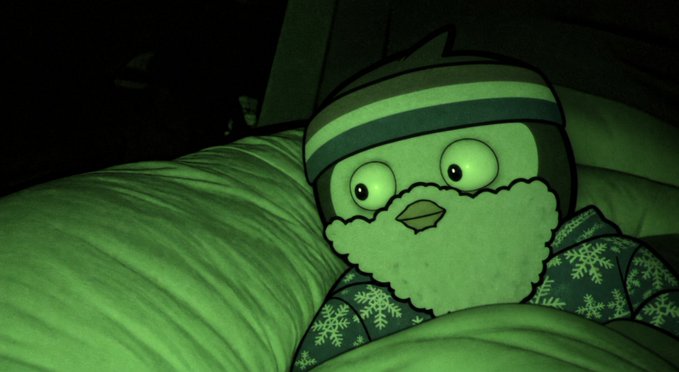 A plush penguin toy with a striped beanie and snowflake-patterned scarf rests against pillows, bathed in an eerie green glow that gives the scene a mysterious, nighttime atmosphere fitting the "early access" hype of the GlimmerGuard launch announcement.