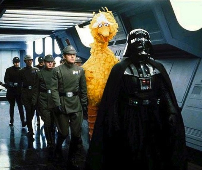 A humorous edited photo showing Big Bird from Sesame Street walking alongside Imperial officers and Darth Vader in a Star Wars Imperial corridor.