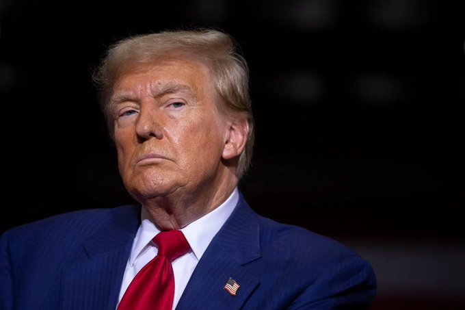 The image features a man wearing a suit, tie, and a pin with an American flag design. The caption reads "President Trump'S memecoin $TRUMP has now closed 7 consecutive red monthly candles. Unbelievable." This statement is likely referring to President Trump's recent decision to close seven red candles on the American flag each month as part of his "Make America Great Again" campaign.