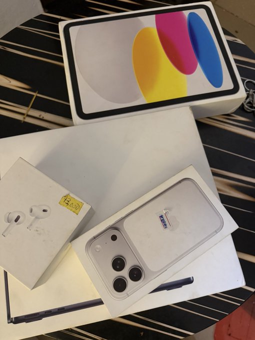 A phone case featuring a "Moonbeam" branded cardholder is displayed alongside AirPods and an iPhone box on a table, with the post humorously attributing the NFT-themed accessories to "degen" crypto culture. The visible text includes "Moonbeam" on the card and "$20.00" written on a yellow sticker.