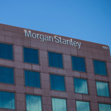 The image shows the upper facade of a Morgan Stanley office building, with the company's name and the number "1501" visible on the exterior. The signage supports the post by confirming Morgan Stanley's involvement in the amended spot Ethereum and Solana ETF filings, where the firm has designated Coinbase as custodian and staking facilitator alongside BNY Mellon.