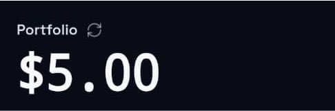 A simple dark screen displays 'Portfolio' with a refresh icon and a large '$5.00' value, resembling a stock or investment portfolio app.