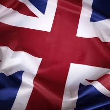 A close-up of a waving Union Jack flag symbolizes the UK as the Financial Conduct Authority (FCA) prepares to announce new standards for tokenized gold to maintain London's dominant ~70% share of global gold trading.