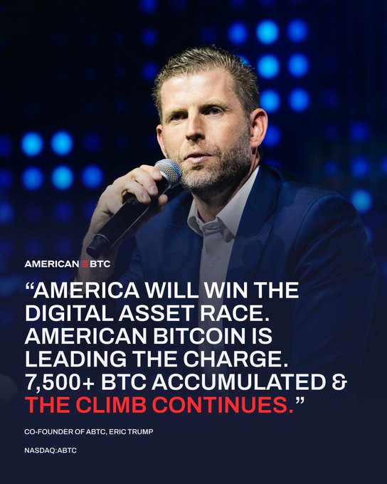 The image features a man wearing a suit and tie speaking into a microphone at an event or gathering. The caption of the image reads "America will win the digital asset race, American bitc coin is leading the charge, 7,500+ BTC accumulated & the climb continues". This suggests that the man's speech might be related to the current state of the cryptocurrency market and its impact on the economy.
