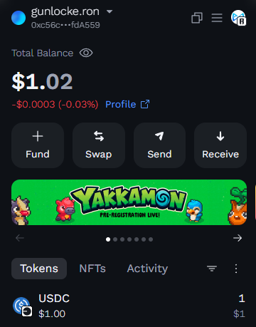 A cryptocurrency wallet interface showing the account 'gunlocke.ron' with a Total Balance of $1.02, holding 1 USDC token, along with a promotional banner for 'Yakkamon Pre-Registration Live!'.