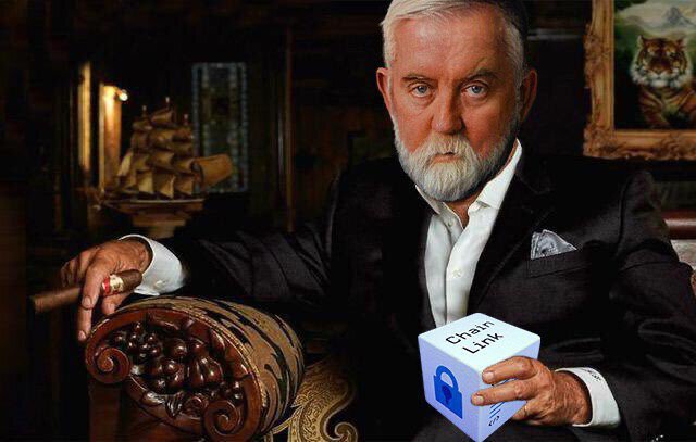 A distinguished older man with white hair and beard, wearing a suit and holding a cigar, sits in an ornate chair while holding a white box labeled 'ChainLink' featuring a blue padlock logo.