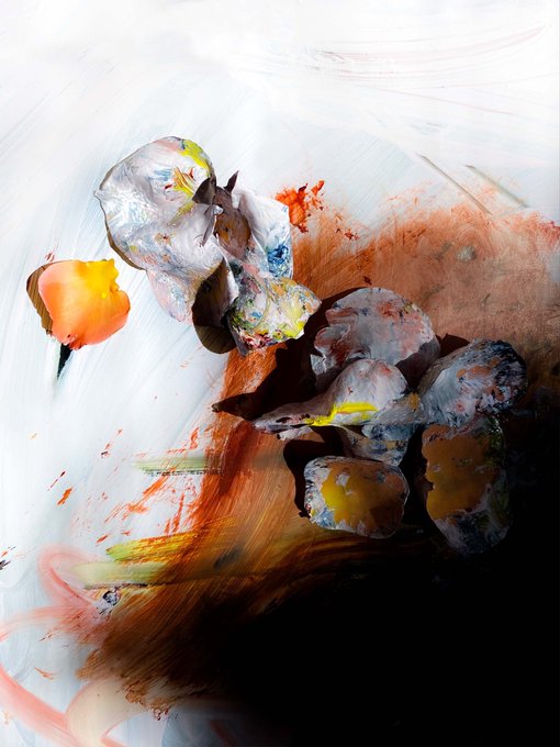 An abstract artwork featuring splashes of brown, orange, and yellow paint, with crumpled, textured shapes resembling flower petals against a white background.