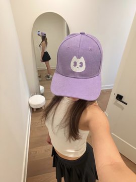 A girl wearing a purple cat-paw baseball cap takes a mirror selfie. The cap matches the brand aesthetic of @TradeBoba, reinforcing the playful meme-coin vibe of the post promoting multi-chain support on Robinhood, Solana, Base, BSC, and Monad.