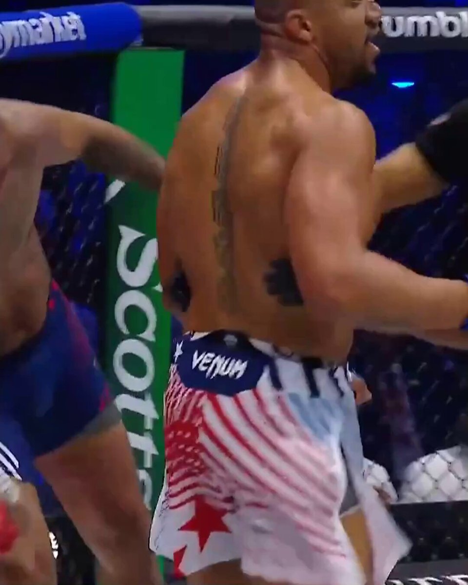 The image shows a man wearing shorts with an American flag design, which appears to be red, white, and blue colors. The shorts are tied at his waist, indicating that he might be participating in a boxing match or fighting event. The background of the image is blurred, but it seems like there's a crowd present, suggesting that this could be a professional boxing event taking place in a stadium. The post also mentions that the man has won the heavyweight championship and is now considered the RD2 TKO (Rookie of the Year), which implies his exceptional skills and achievements as a boxer.