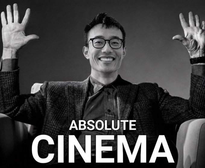 A black and white meme image of a smiling man with raised hands in a '10' gesture with the text 'ABSOLUTE CINEMA'.