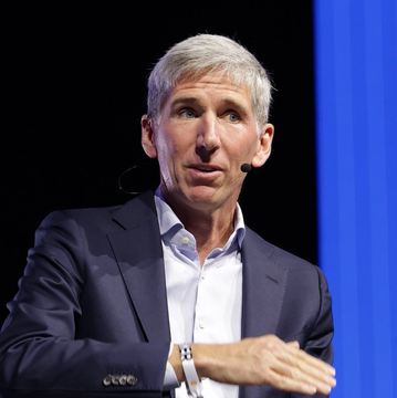A man in a navy blazer with a headset microphone speaks at what appears to be a conference or panel discussion. The image accompanies a post predicting Bitcoin could reach $1.3 million by 2035, though the speaker's identity cannot be confirmed from the image alone.
