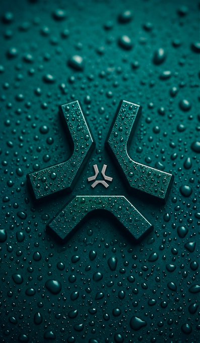 A dark teal 3D logo resembling an angular 'X' or stylized letterform, covered in water droplets against a matching wet, beaded background.