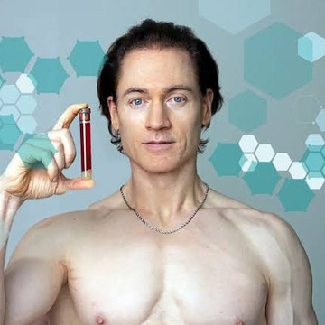 A shirtless Bryan Johnson holds up a vial of red liquid (likely blood) against a background of teal hexagons. The image ties to his quote about longevity and longevity protocols, visually reinforcing his quest to dramatically extend human lifespan so he can witness the 2140 Bitcoin halving.