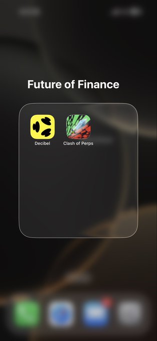 An iOS folder titled 'Future of Finance' containing two apps: 'Decibel' (yellow icon) and 'Clash of Perps' (gnome icon), displayed on an iPhone home screen.