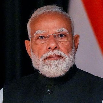 A close-up of Indian Prime Minister Narendra Modi, in a black jacket with the Indian flag behind him, accompanies a post about the Reserve Bank of India's recent stance on cryptocurrency regulation, which calls for policies "leaning towards prohibition" by restricting banks from engaging with crypto, despite 39 million Indians trading $2.1 billion in digital assets.
