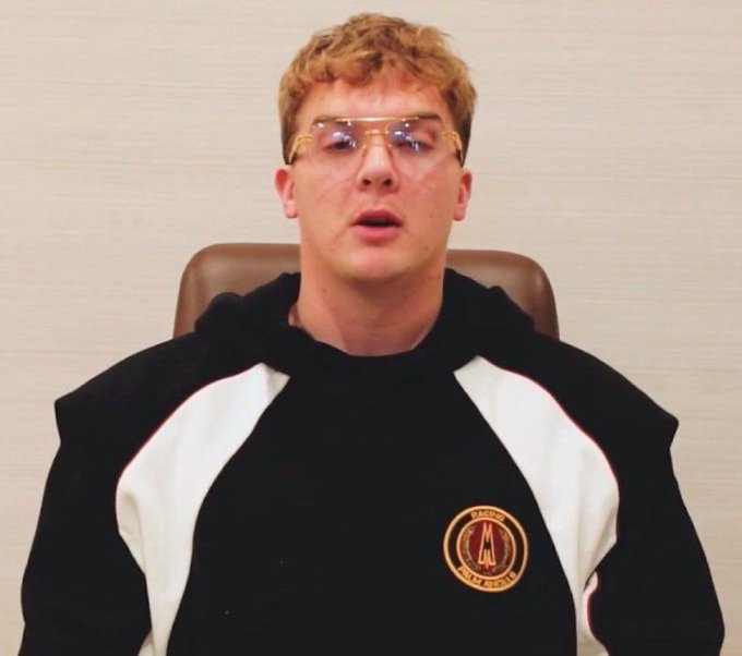 A young man with blond curly hair and safety glasses sits wearing a black and white hoodie featuring an "AS Roma Football Club" crest. The image accompanies a post about Hayden Davis and his connection to the $LIBRA memecoin case.