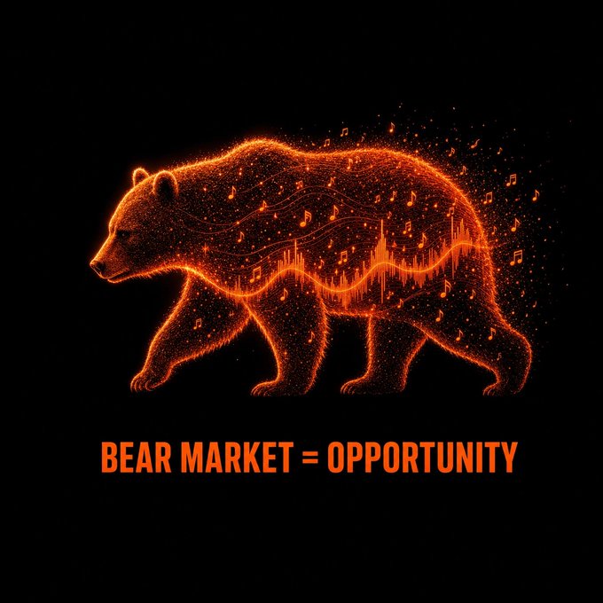The image features a bear walking across a black background with orange particles scattered around it. The bear is depicted as a large, glowing creature that stands out against the dark backdrop. Below the bear, there's text written in white letters that reads "Bear Market = Opportunity". This phrase suggests that the bear market conditions are favorable for investing and creating opportunities.
