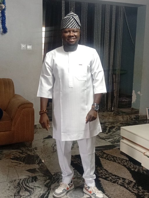 A man poses in traditional white Yoruba attire (agbada and fila cap) along with sneakers, ready for the @arc meetup in Abuja as mentioned in the post. The image reflects his preparation to greet attendees at the event with the "Build. On. Arc" theme.